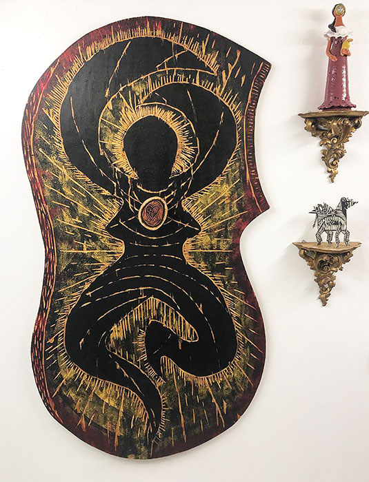 Shaped black Venus plaque and figurines